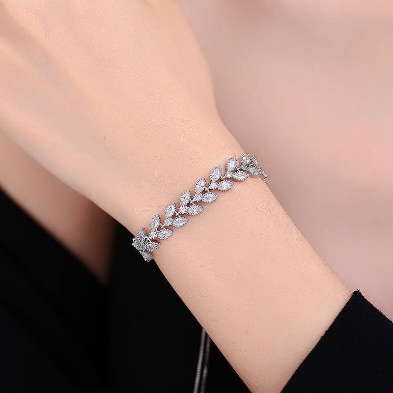 Moissanite Petal Bracelet - Silver Wheat Moissanite design on wrist, featuring sterling silver leaves with sparkling Moissanite stones. Elegant jewelry for women.