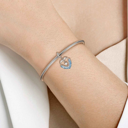 Dolphin Heart Charm - Ocean Lover Keepsake worn on a silver bracelet, showcasing its elegant ocean-inspired design with sparkling crystals.
