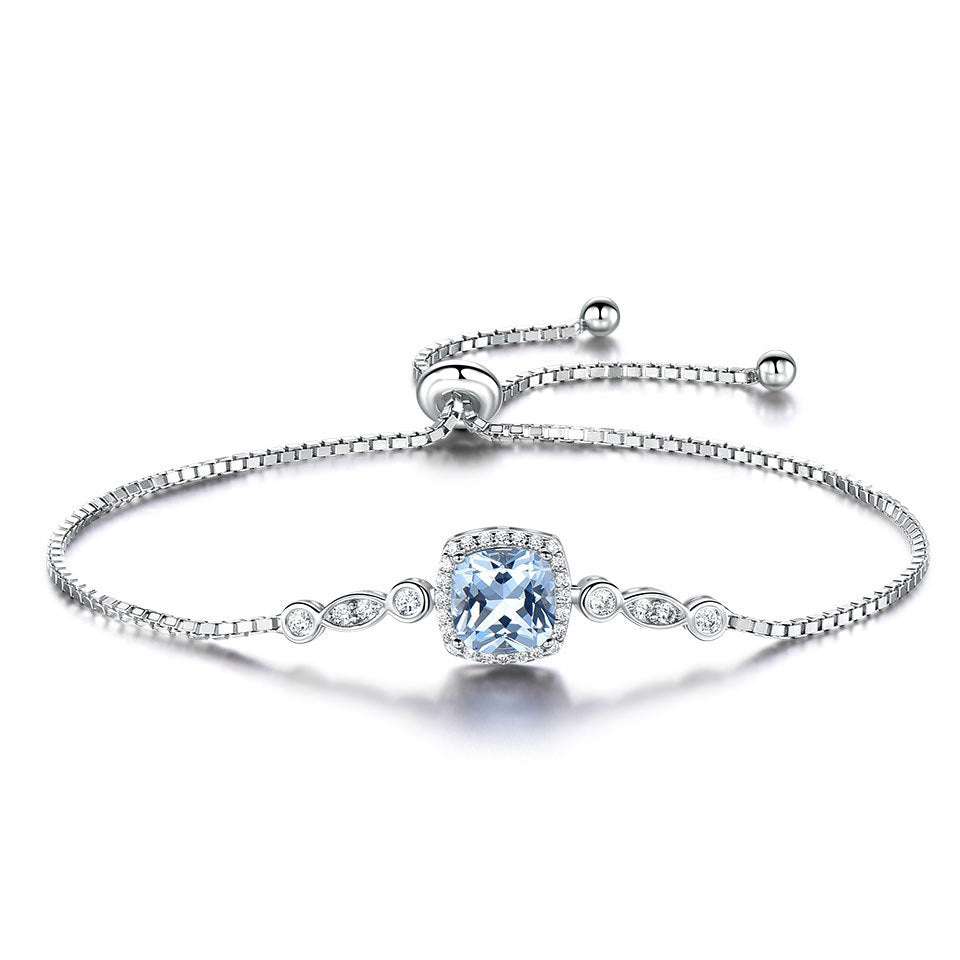 Silver Topaz Bracelet featuring a cushion-cut topaz centerpiece with adjustable chain and delicate crystal accents. Elegant wrist jewellery for any occasion.