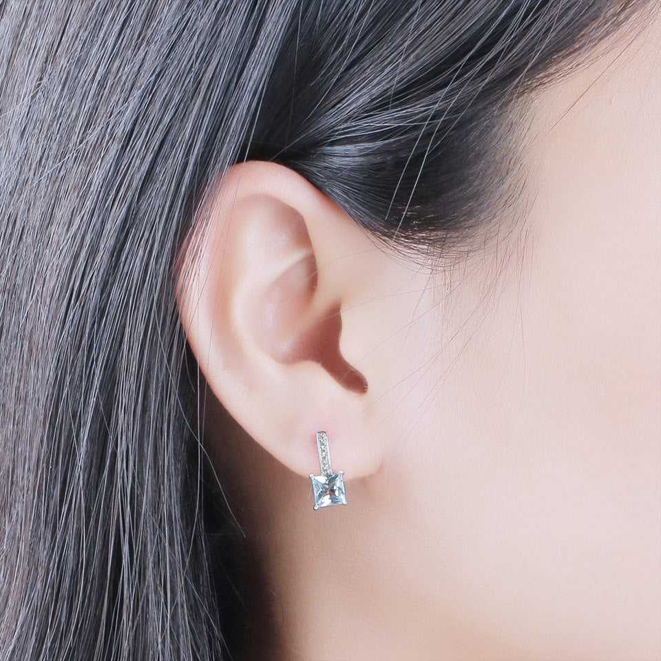 Sky Blue Topaz Earrings - Silver Craftsmanship worn on ear, demonstrating elegant fit and radiant gemstone appeal for everyday or formal wear.