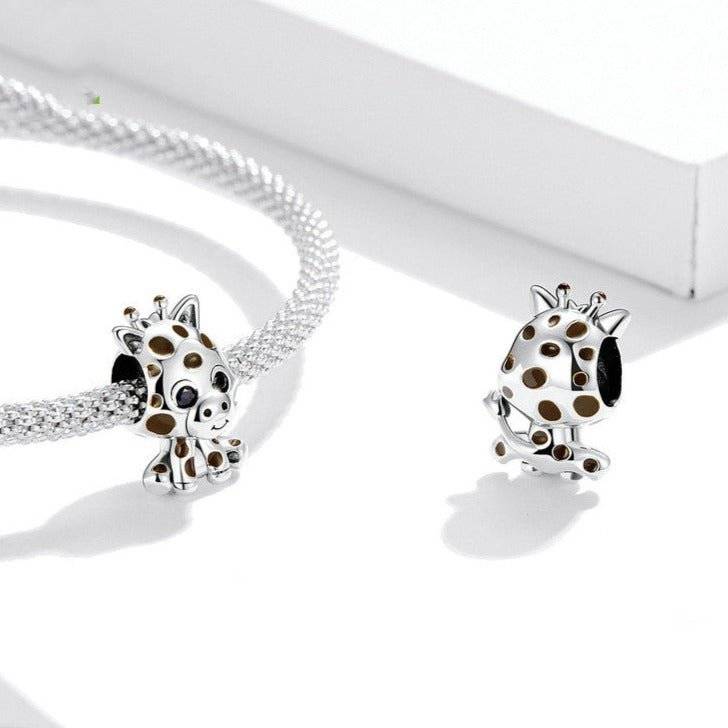 Adorable Baby Giraffe Charm in silver with brown spots, designed for animal lovers. Fits perfectly on charm bracelets or necklaces.