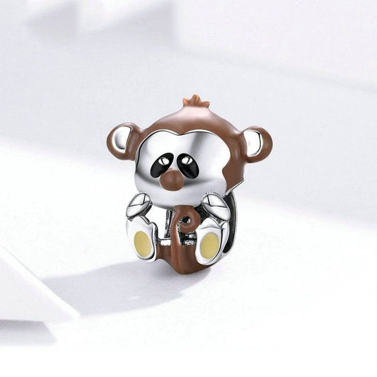 Adorable Baby Monkey Charm in brown and silver enamel, perfect for playful bracelet customization. Adds cute jungle flair to your jewelry collection.