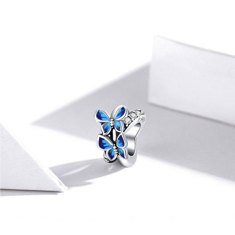 Charming Butterfly Spacer featuring blue enamel wings and silver detailing, perfect for enhancing bracelet elegance in jewelry collections.