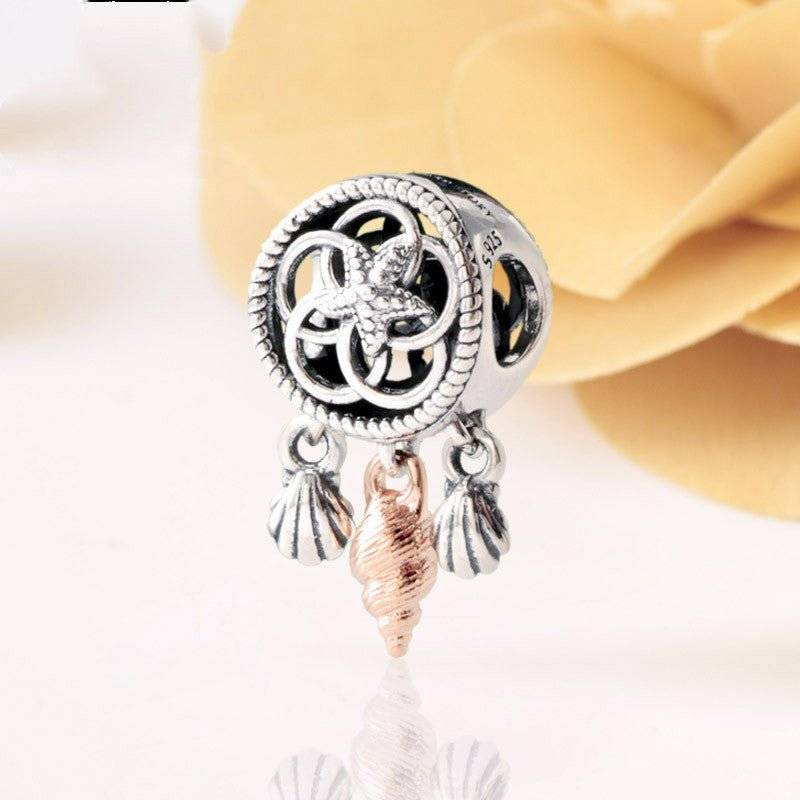 Dreamcatcher Charm - Capture Your Dreams & Wishes 🌙✨ featuring intricate silver detailing with dangling shell accents in silver and rose gold tones.