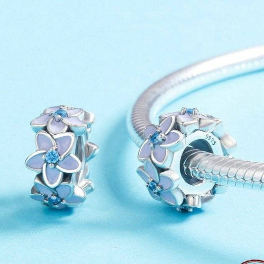 Elegant flower spacers for charm bracelets featuring blue enamel petals and crystal centers, ideal jewellery accessory for personalized bracelets.