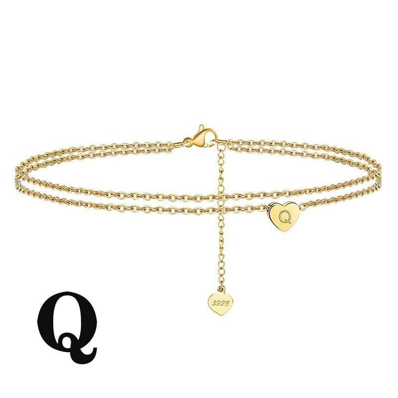 Custom Letter Heart Anklet with 'Q' engraved charm. Elegant gold-plated design for a unique fashion accessory.