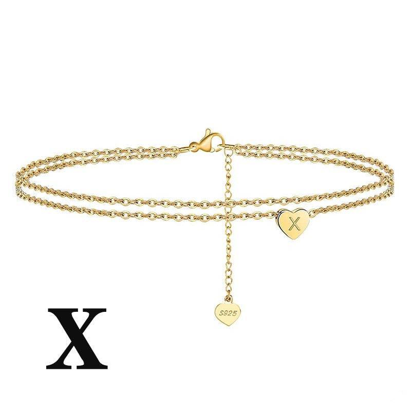 Gold Letter Heart Anklet with 'X' initial charm. Personalized and stylish ankle bracelet made from sterling silver.