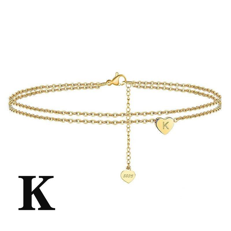 Gold Letter Heart Anklet with 'K' initial charm. Elegant and adjustable ankle bracelet for personalized style.