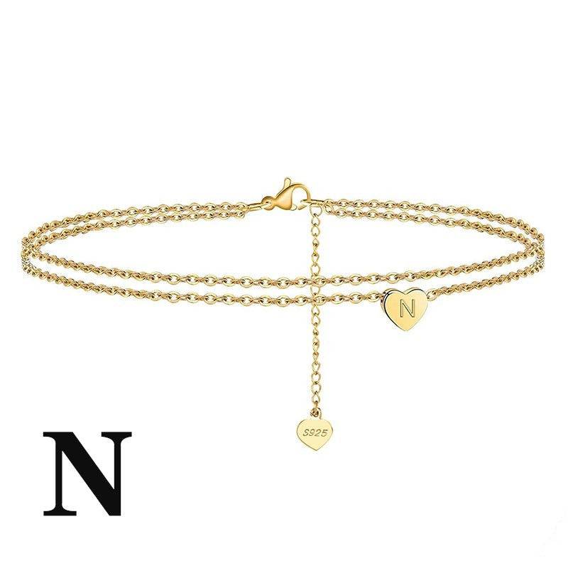 Letter Heart Anklet with 'N' engraved charm in gold finish. Chic and dainty ankle bracelet for everyday wear.