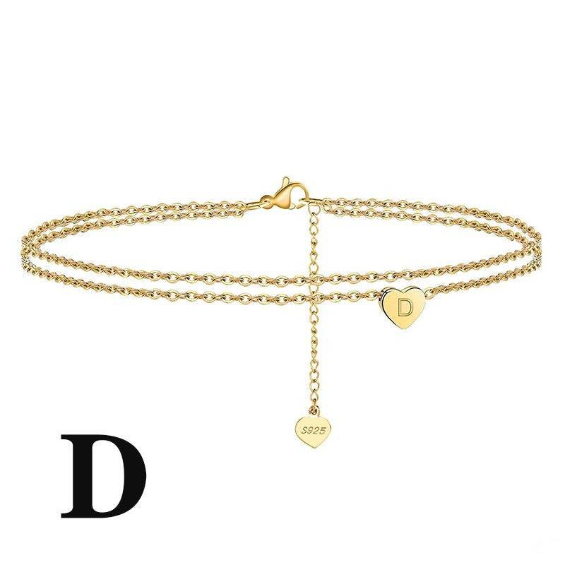 Gold Letter Heart Anklet featuring engraved 'D' charm on heart pendant. Unique jewelry piece made from 925 sterling silver.