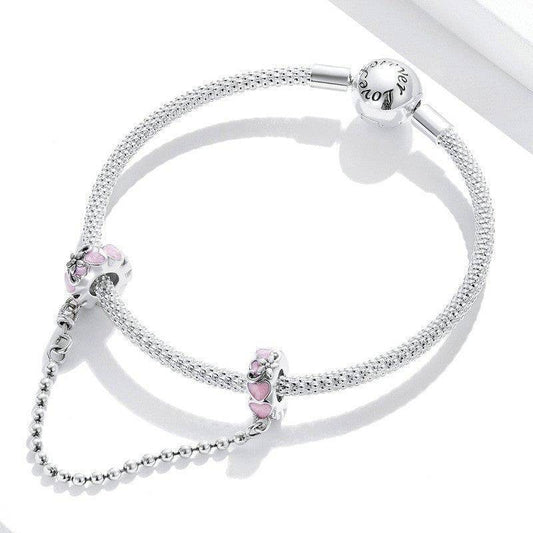 Elegant Heart Safety Chain featuring pink enamel hearts on silver charms, designed to secure bracelets with style and love. Ideal for charm bracelets.