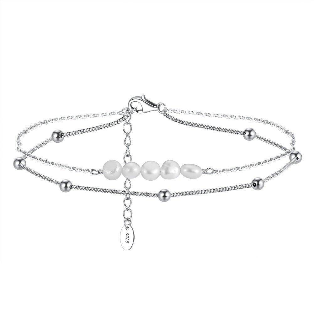 Elegant Pearl Anklet in sterling silver with layered chains and freshwater pearls, perfect for formal and casual outfits. Timeless jewelry piece.