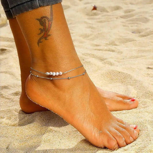 Elegant Pearl Anklet worn on a beach, showcasing its delicate design and versatility for summer or vacation fashion. Ideal for barefoot elegance.