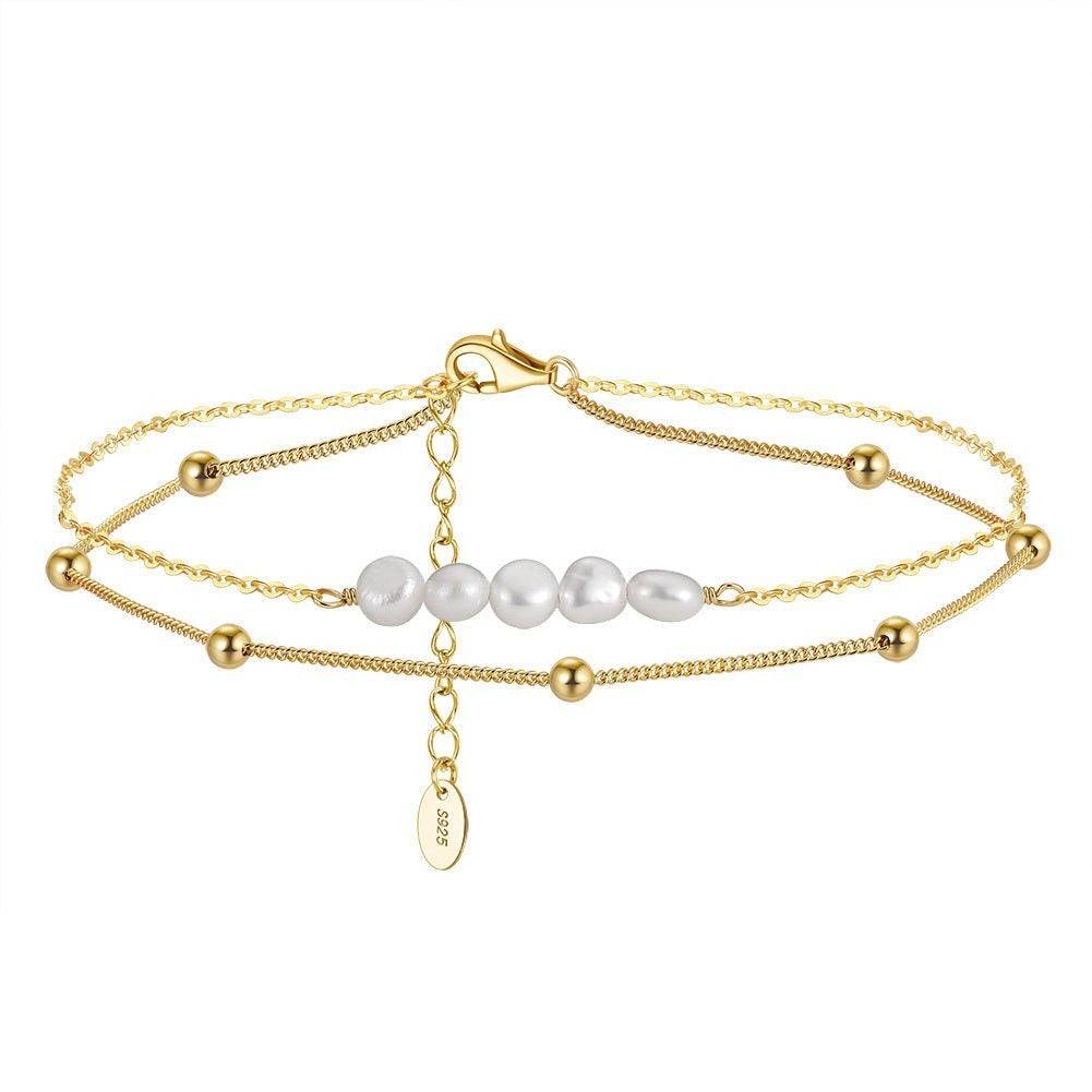 Elegant Pearl Anklet in gold finish with layered chains and lustrous pearls, offering a luxurious touch to any jewelry collection. Great gift idea.