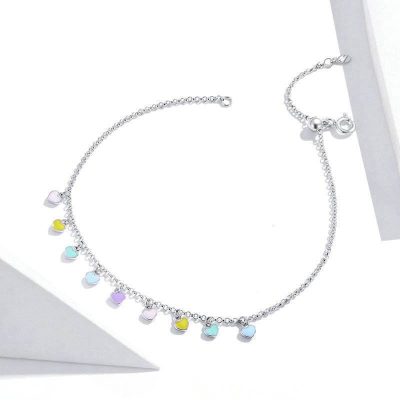 Sterling silver Rainbow Heart Anklet displayed in bright lighting, highlighting its vivid heart charms and elegant chain design.