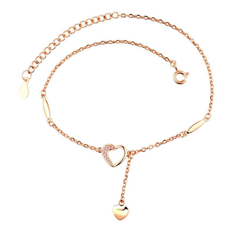 Charming Heart Anklet in rose gold with dangling heart charm and crystal-accented open heart, ideal for elegant everyday wear.