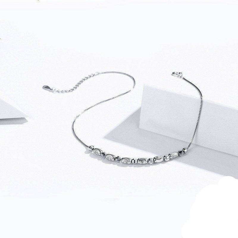 Classic Simple Sterling Silver Anklet laid flat with adjustable chain, emphasizing its lightweight and versatile design.
