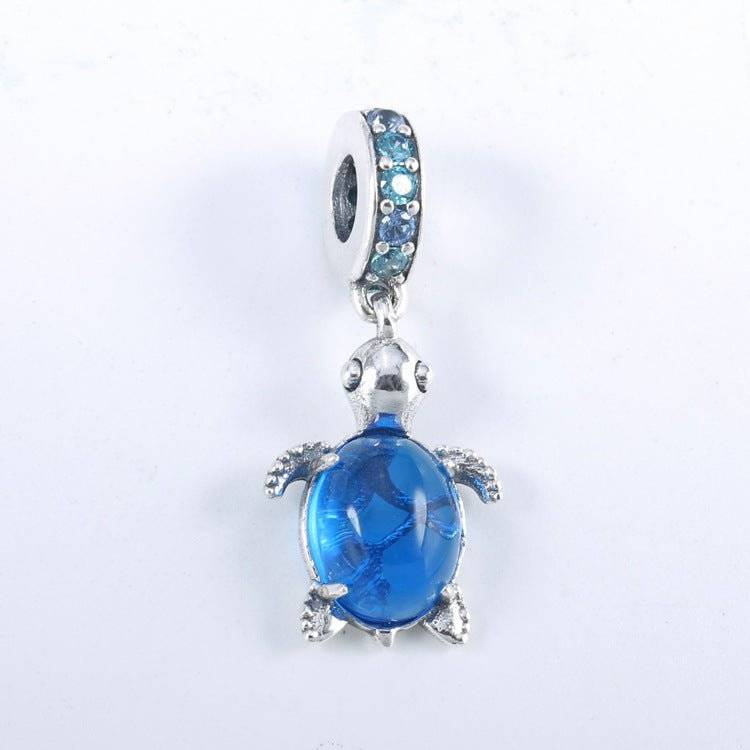Charming Turtle Charm featuring a blue crystal shell and silver detailing, symbolizing wisdom and resilience for bracelets or necklaces.