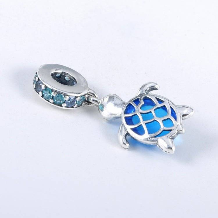 Charming Turtle Charm featuring a silver turtle with a vibrant blue crystal shell, symbolizing wisdom and resilience for bracelets or necklaces.