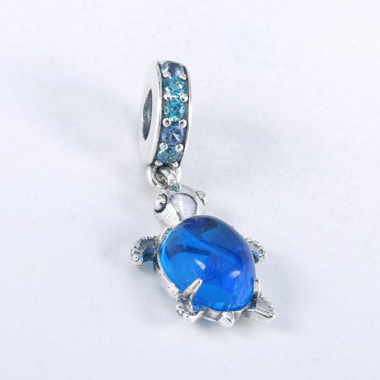 Charming Turtle Charm featuring a vibrant blue crystal shell and silver body, symbolizing wisdom and resilience in jewelry accessories.