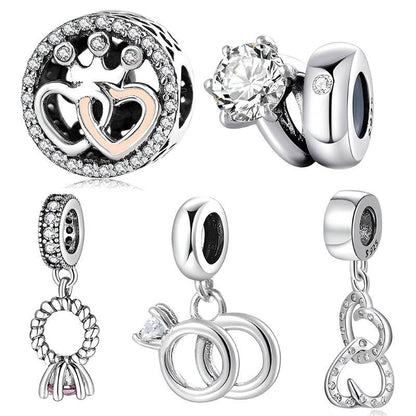 Elegant silver charm set with hearts and rings