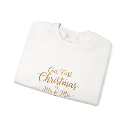 His/Hers Newlyweds Sweatshirt folded in white with gold script reading 'Our First Christmas as Mr. & Mrs.' Ideal holiday apparel for couples.