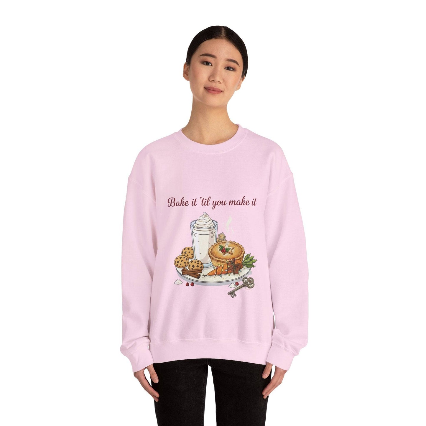 Women’s Sweatshirt - “Bake it ‘til you make it” in light pink with embroidered pastries, coffee, and wine charm, ideal for cozy fall fashion.