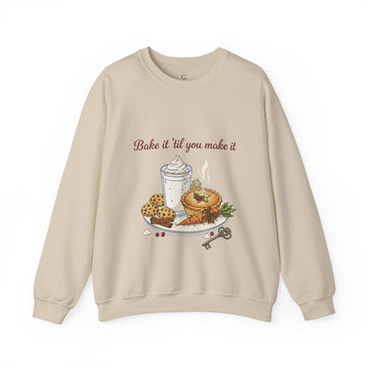Women’s Sweatshirt - “Bake it ‘til you make it” in beige with embroidered pie, cookies, and whipped drink design. Cozy holiday apparel for wine lovers.