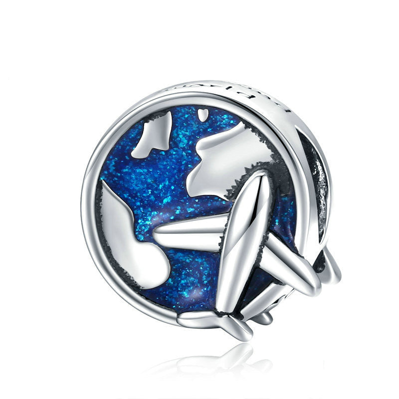 Travel Charm featuring a sterling silver airplane over a blue enamel globe. A perfect good luck charm for travelers seeking protection and adventure.