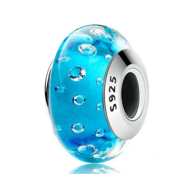 Blue glass bubble charm with bubble pattern