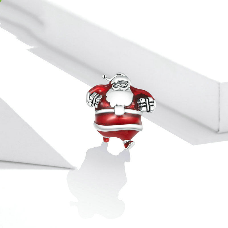 Santa charm on white surface, festive decoration