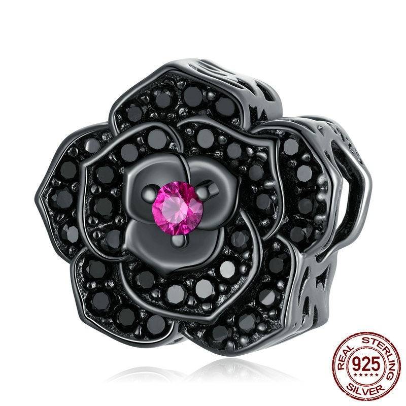 Gothic Charm: Embrace Dark Elegance - Black Rose features a black sterling silver rose charm with black stones and a central pink gem. Ideal for gothic style jewelry collections.