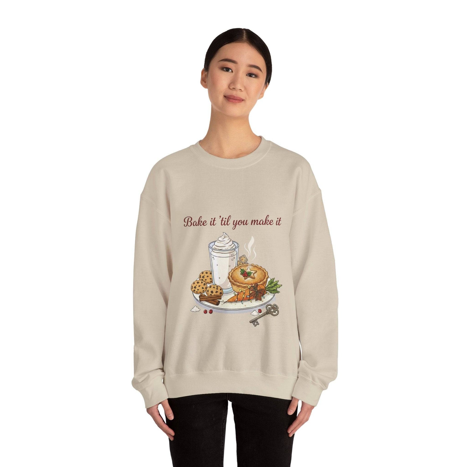Women’s Sweatshirt - “Bake it ‘til you make it” features cozy food and wine-themed embroidery with cookies, coffee, and bagel on beige crewneck.