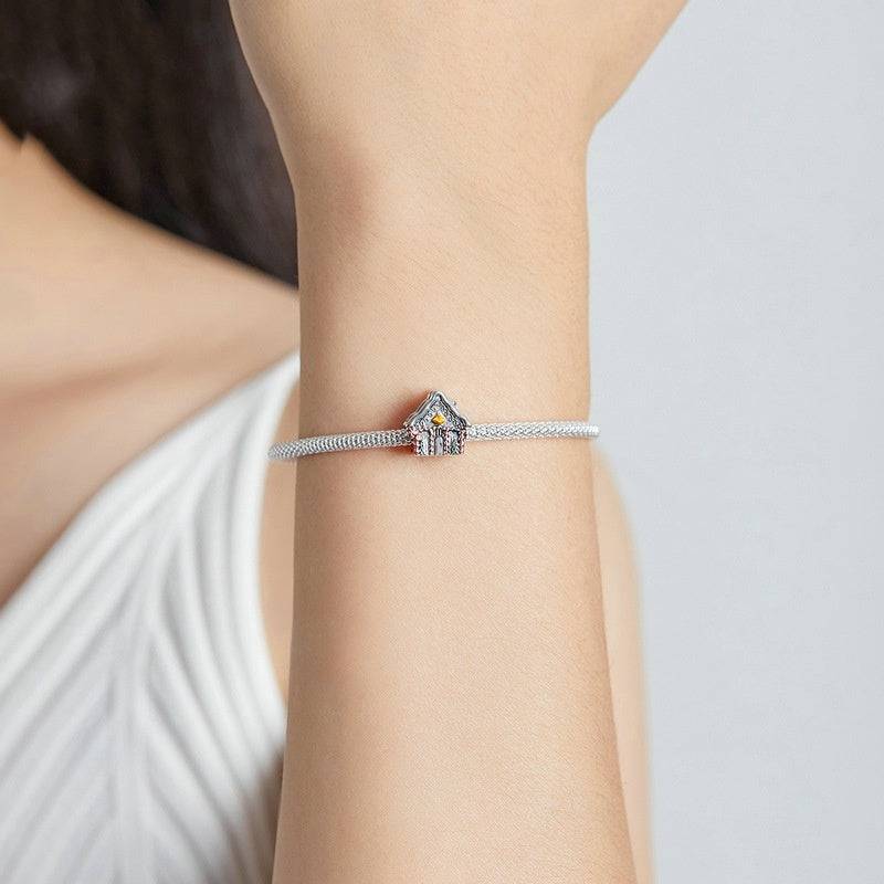 Christmas House Charm on silver bracelet featuring a winter cottage design with festive colors. Ideal for holiday-themed jewelry collections.