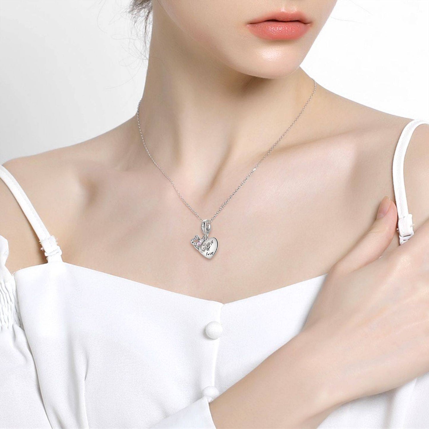 Woman wearing necklace with Gift of Love Charm