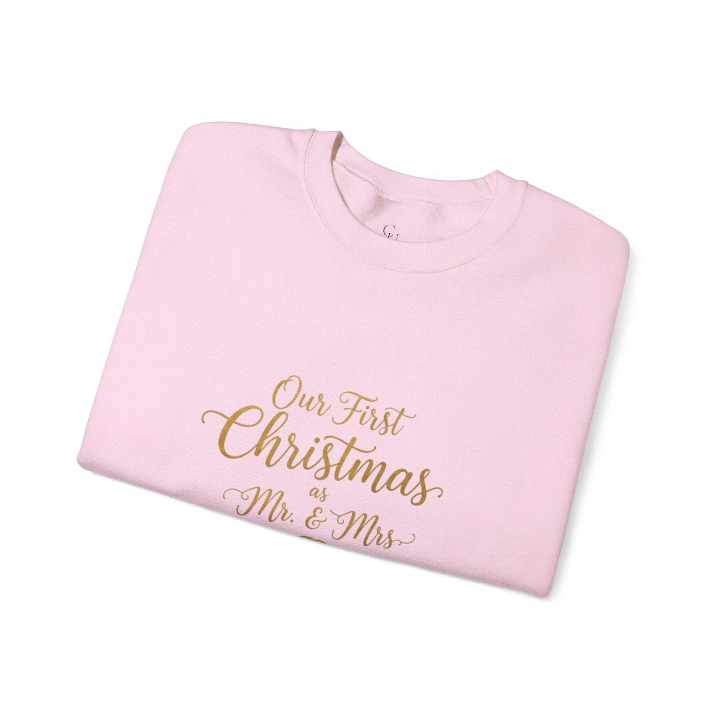 His/Hers Newlyweds Sweatshirt in light pink with gold script reading 'Our First Christmas as Mr. & Mrs.' Ideal holiday apparel for couples.