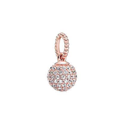Rose gold charm with clear gemstones on a white background