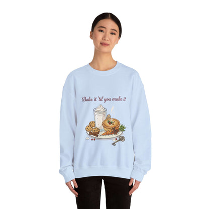 Women’s Sweatshirt - “Bake it ‘til you make it” in light blue with festive baked goods and wine-themed embroidery, perfect for cozy fall fashion.
