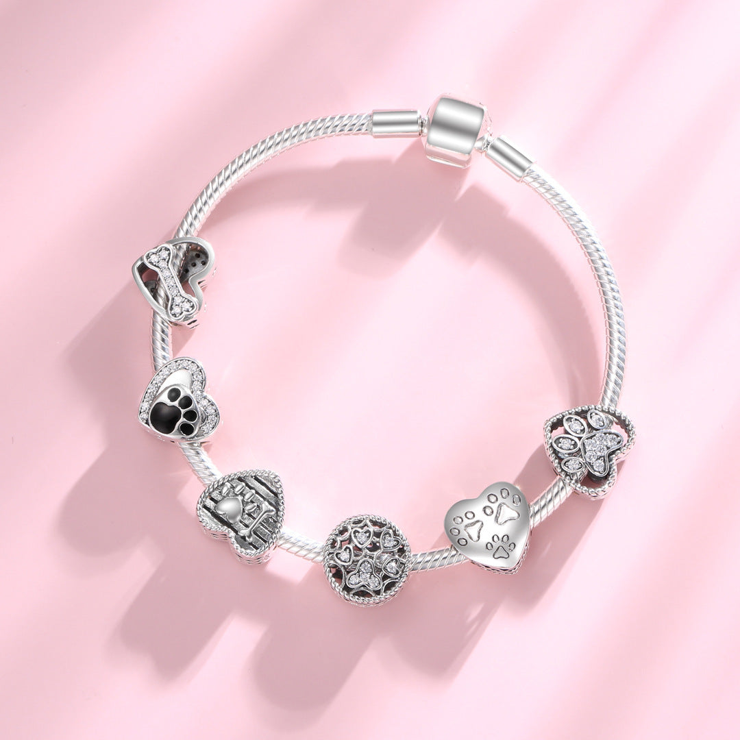 Silver bracelet with six pet-themed charms