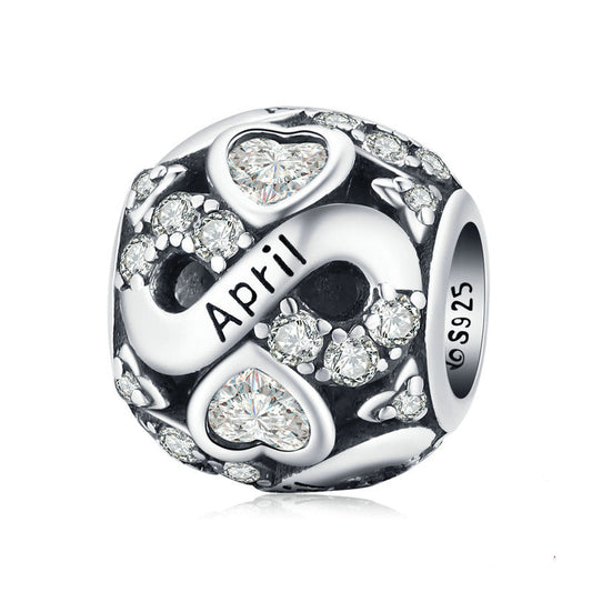 Silver charm with 'April' and heart designs on a white background
