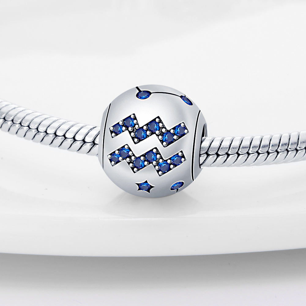 Aquarius zodiac charm in sterling silver with blue crystal accents, perfect for adding a personalized touch to bracelets.