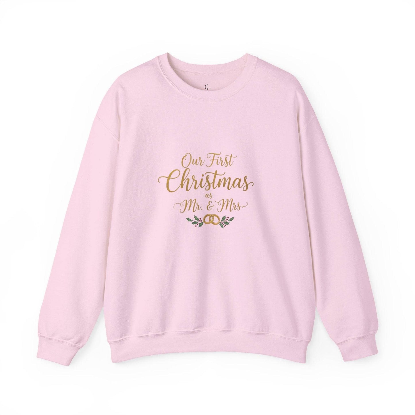 His/Hers Newlyweds Sweatshirt in pastel pink with 'Our First Christmas as Mr. & Mrs.' gold embroidery. Cozy unisex crewneck for holiday gifting.