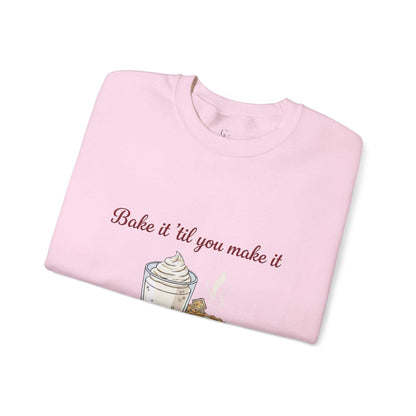 Women’s Sweatshirt - “Bake it ‘til you make it” in pastel pink with embroidered whipped drink and cookie design, ideal for cozy wine-themed outfits.