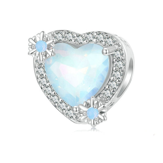 Heart-shaped silver pendant with a blue opal stone on a white background