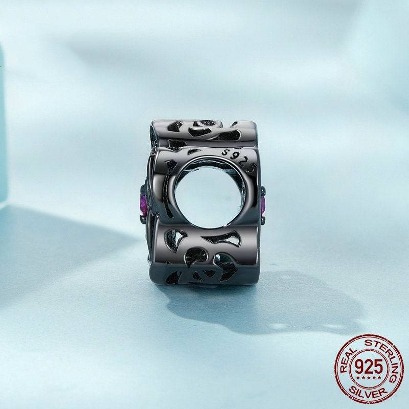 Black Rose Gothic Charm in sterling silver with skull and bone cutout design. Gothic Style charm for dark elegance jewelry collections.