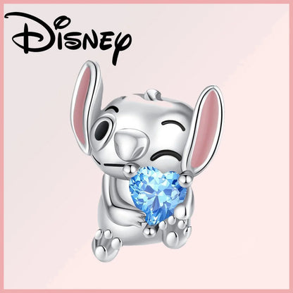 Limited Edition Disney Pixar charm featuring a silver Stitch holding a blue heart-shaped zircon gem. Part of the Disney Pixar Charms Collection.
