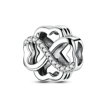 Silver charm with interlocking hearts and clear stones on a white background, featuring 'Real Sterling Silver 925' stamp.