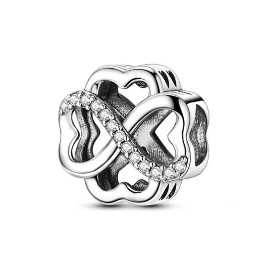 Silver charm with interlocking hearts and clear stones on a white background, featuring 'Real Sterling Silver 925' stamp.