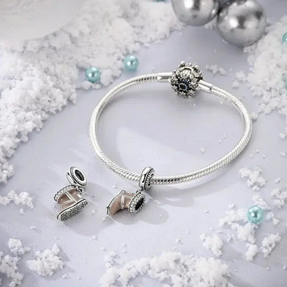 Snow Boot Charm - Winter Accessory | Symbol of Warmth featured on a silver bracelet surrounded by snow and festive ornaments. Ideal for seasonal jewelry.