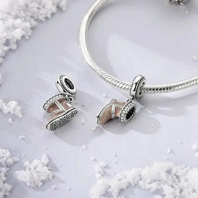 Snow Boot Charm - Winter Accessory | Symbol of Warmth displayed on a silver bracelet with snowflake accents, perfect for seasonal jewelry collections.